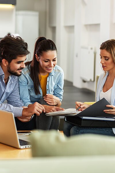 Family reviewing mortgage paperwork with a lender